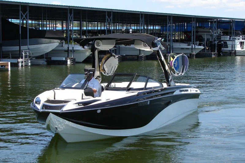 Slide: The Image of 2019 Centurion Ri257 boat on water near marina docks. - 3
