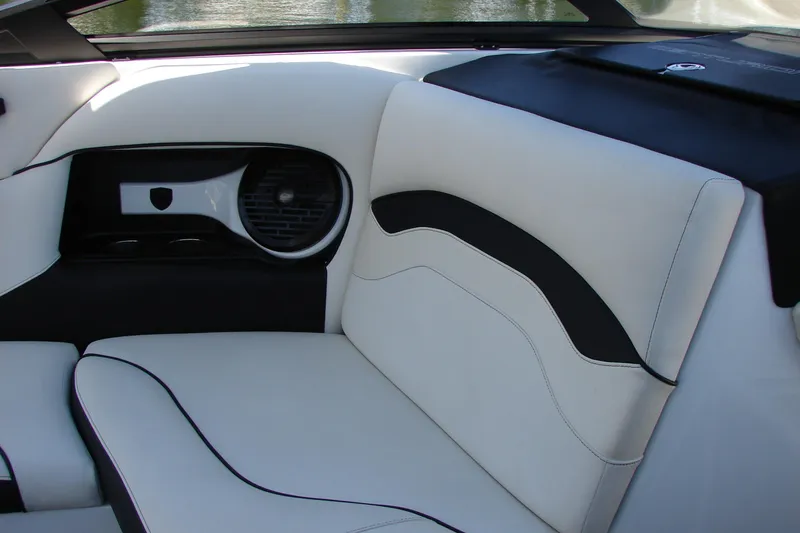 Slide: The Image of 2019 Centurion Ri257 boat interior with white and black seating, featuring speaker detail. - 37