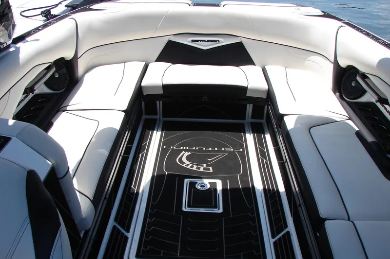 Slide: The Image of 2019 Centurion Ri257 boat interior with luxurious white seating and sleek black flooring. - 38