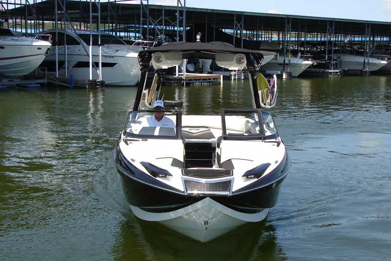 Slide: The Image of 2019 Centurion Ri257 boat docked in marina, surrounded by other vessels. - 4