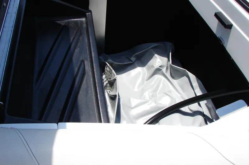 Slide: The Image of Storage compartment of 2019 Centurion Ri257 boat with black and gray interior. - 44
