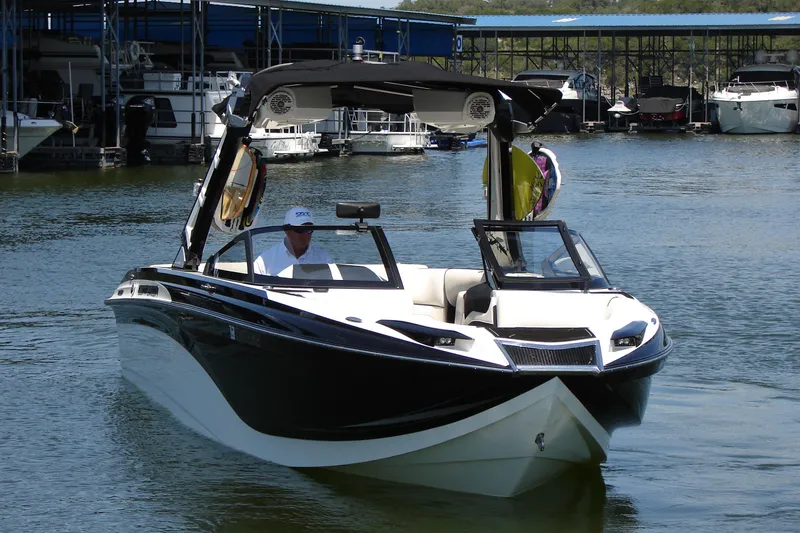 Slide: The Image of 2019 Centurion Ri257 boat on water near marina docks. - 5