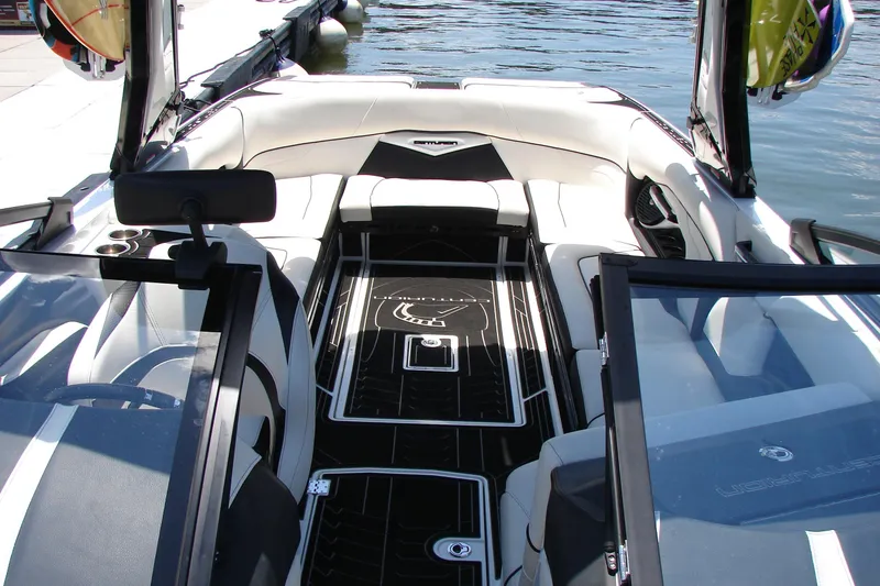 Slide: The Image of 2019 Centurion Ri257 boat interior with sleek seating and modern design on the water. - 50