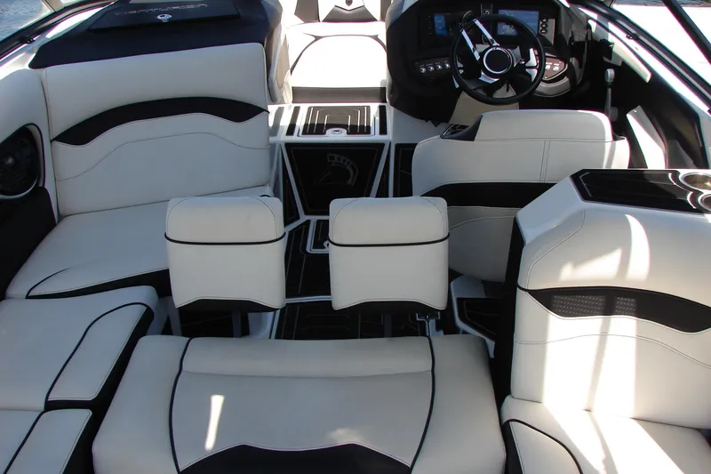 Slide: The Image of 2019 Centurion Ri257 boat interior with luxurious white seating and modern dashboard. - 56