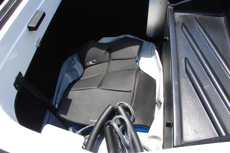 Slide: The Image of Storage compartment of 2019 Centurion Ri257 boat with life vest and rope. - 57