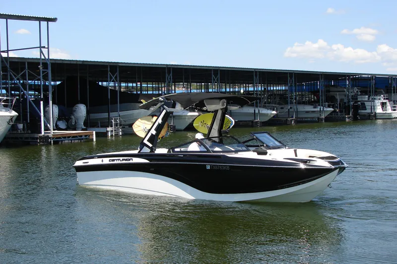 Slide: The Image of 2019 Centurion Ri257 boat docked at marina under clear blue sky. - 8