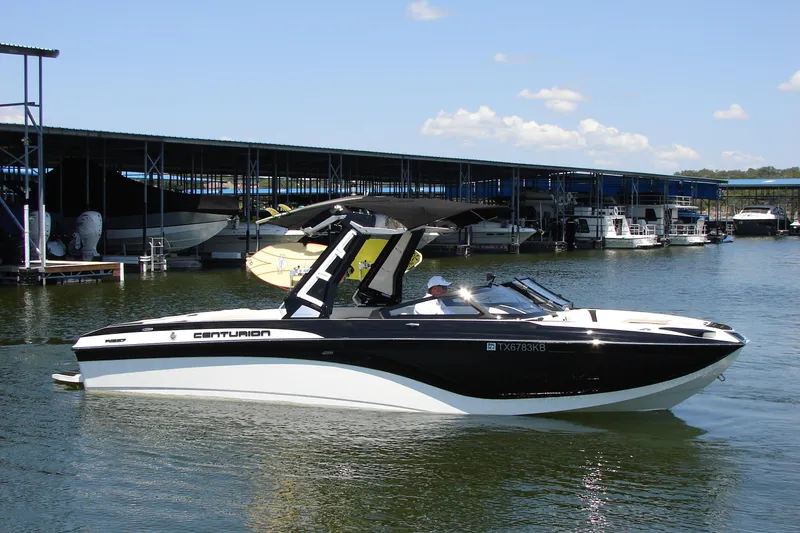 Slide: The Image of 2019 Centurion Ri257 boat on water near marina, clear sky background. - 9
