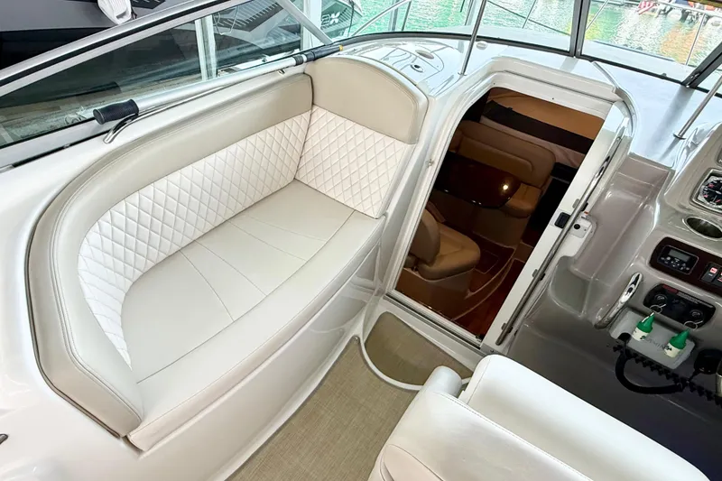 Slide: The Image of 2016 Chaparral 290 Signature boat interior with white seating and cabin entrance. - 14