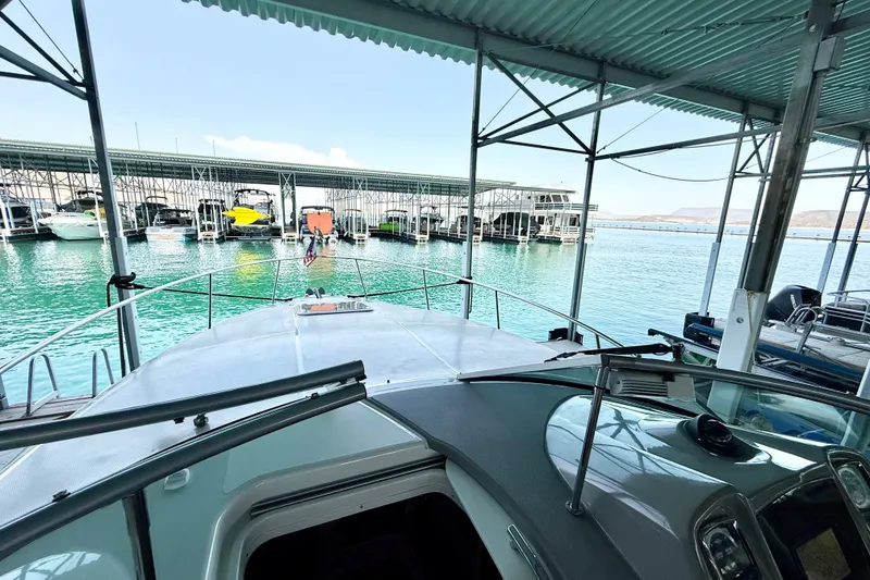 Slide: The Image of 2016 Chaparral 290 Signature docked in a marina with clear turquoise water. - 16