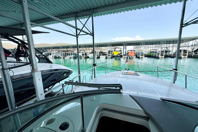 Slide: The Image of 2016 Chaparral 290 Signature docked in a marina with clear turquoise water. - 17