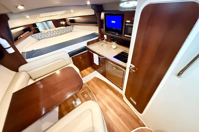 Slide: The Image of Luxurious 2016 Chaparral 290 Signature cabin interior with kitchenette and cozy seating area. - 19