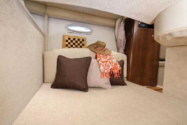 Slide: The Image of 2016 Chaparral 290 Signature cabin interior with cushions, hat, and chessboard. - 25
