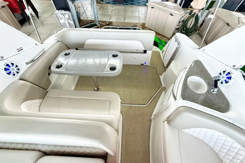 Slide: The Image of 2016 Chaparral 290 Signature boat interior with seating, table, and sink. - 29