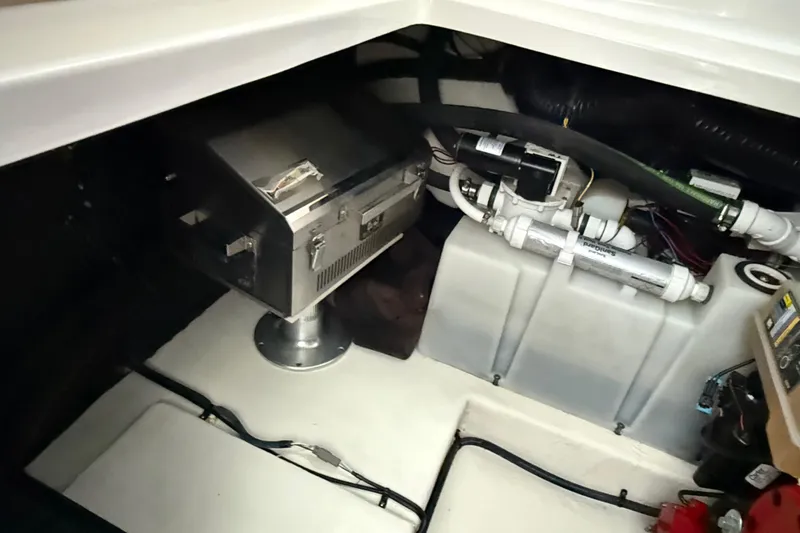 Slide: The Image of Engine compartment of 2016 Chaparral 290 Signature boat, featuring mechanical components and wiring. - 34