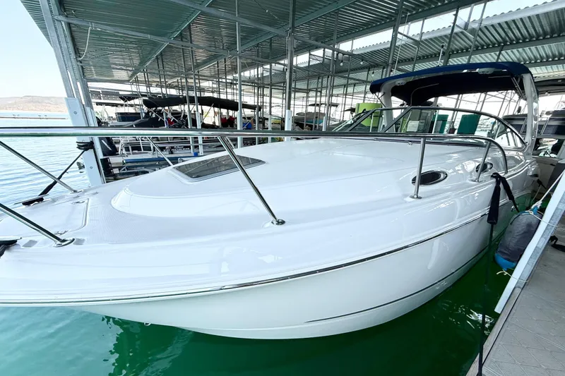 Slide: The Image of 2016 Chaparral 290 Signature boat docked in a marina, under a metal canopy. - 4
