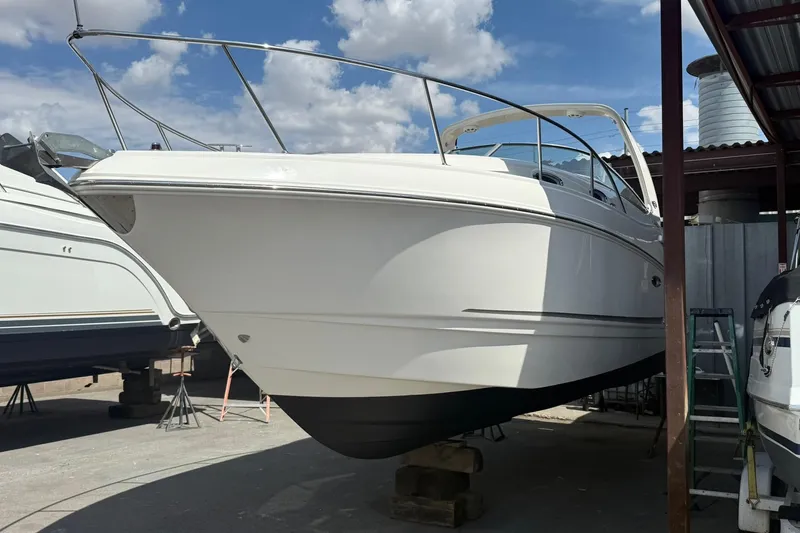 Slide: The Image of 2016 Chaparral 290 Signature boat on dry dock under a cloudy sky. - 43