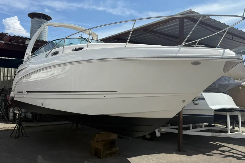 Slide: The Image of 2016 Chaparral 290 Signature boat in storage, showcasing sleek design and white exterior. - 44