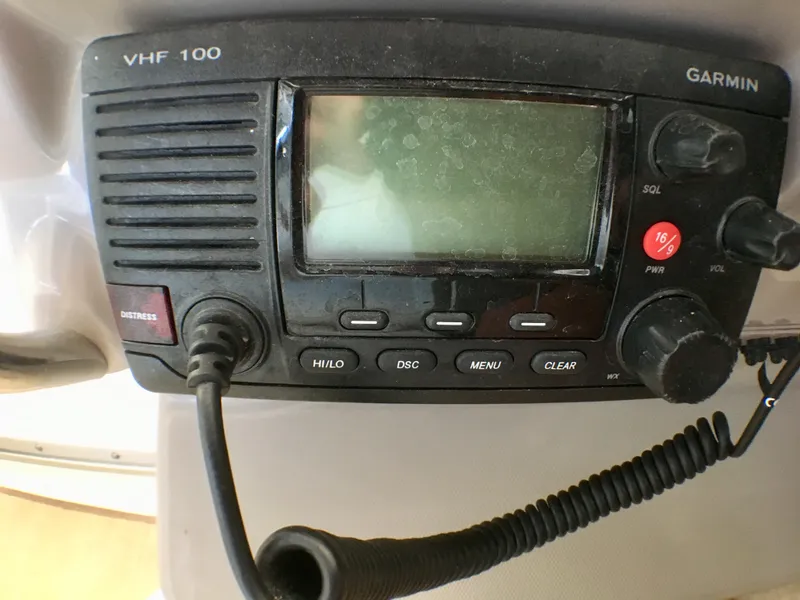 Slide: The Image of VHF 100 Garmin radio on 2016 Chaparral 290 Signature boat dashboard. - 47