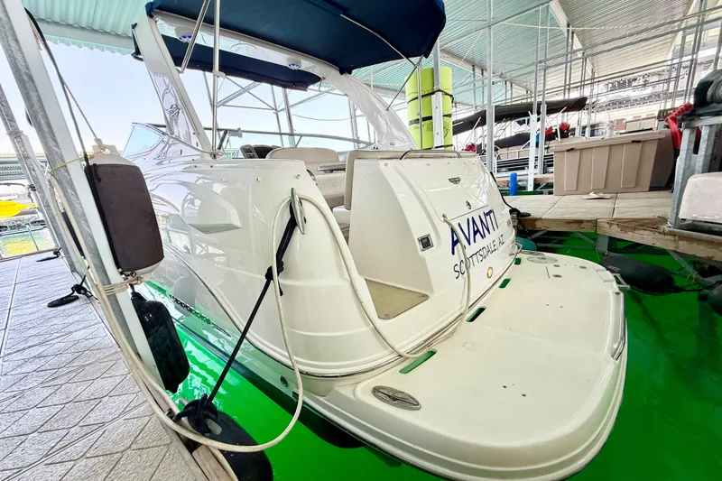 Slide: The Image of 2016 Chaparral 290 Signature boat docked under a covered marina. - 5