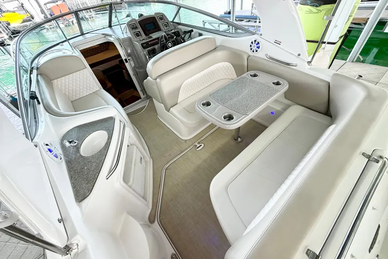 Slide: The Image of 2016 Chaparral 290 Signature boat interior with seating and table, docked at marina. - 7