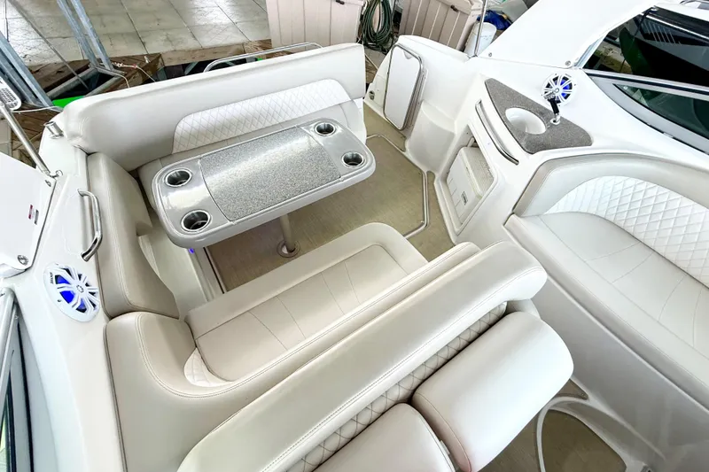 Slide: The Image of Interior of 2016 Chaparral 290 Signature boat with white seating and table. - 8