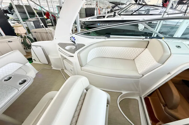 Slide: The Image of 2016 Chaparral 290 Signature boat interior with white seating and cup holders. - 9