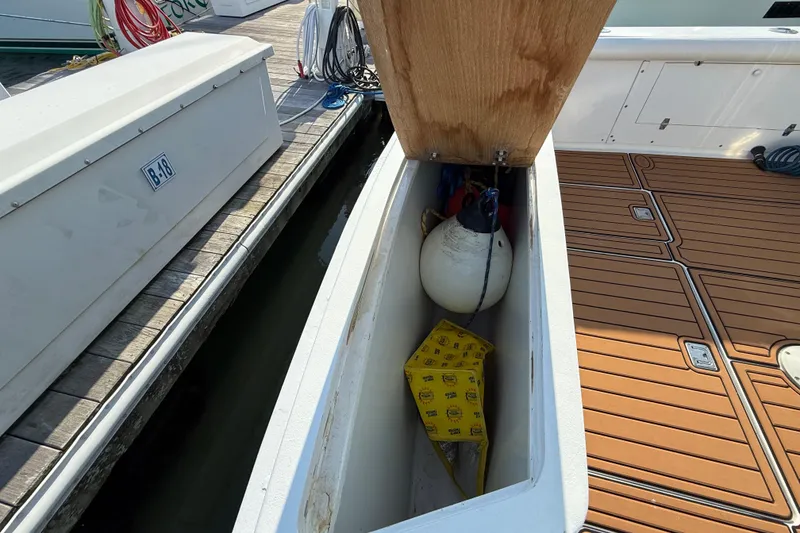 Slide: The Image of Storage compartment on 1979 Bertram 35 Flybridge boat with fender and yellow box. - 14