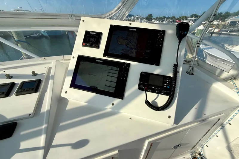Slide: The Image of 1979 Bertram 35 Flybridge helm with modern navigation equipment and controls. - 16