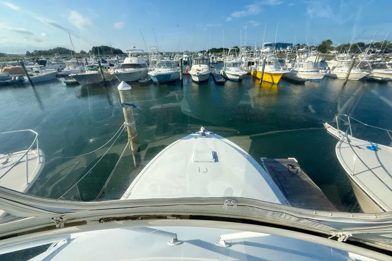 Slide: The Image of View from 1979 Bertram 35 Flybridge overlooking marina with multiple docked boats. - 22