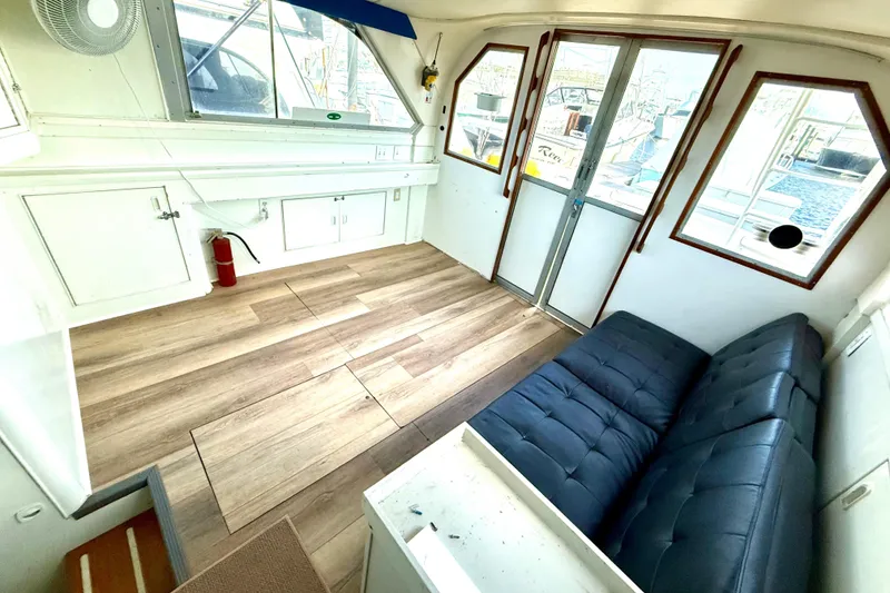 Slide: The Image of Interior of 1979 Bertram 35 Flybridge with wood flooring and blue seating. - 27
