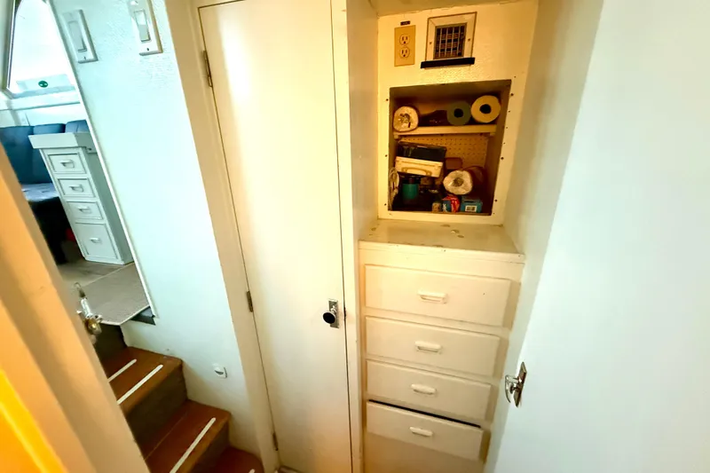 Slide: The Image of 1979 Bertram 35 Flybridge interior with storage shelves and drawers. - 33