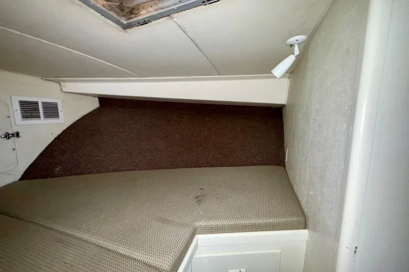 Slide: The Image of 1979 Bertram 35 Flybridge cabin interior with bed and overhead light. - 37