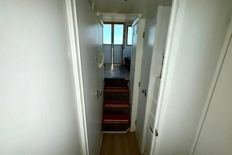 Slide: The Image of Interior hallway of a 1979 Bertram 35 Flybridge boat with stairs and doors. - 39
