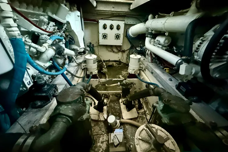 Slide: The Image of Engine room of a 1979 Bertram 35 Flybridge boat, showcasing mechanical components and piping. - 40