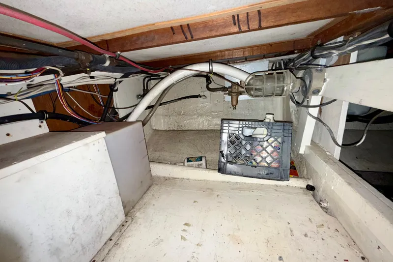 Slide: The Image of Interior view of a 1979 Bertram 35 Flybridge boat showing wiring and storage area. - 45