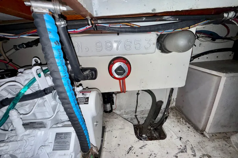 Slide: The Image of Engine room of a 1979 Bertram 35 Flybridge with visible wiring and components. - 46