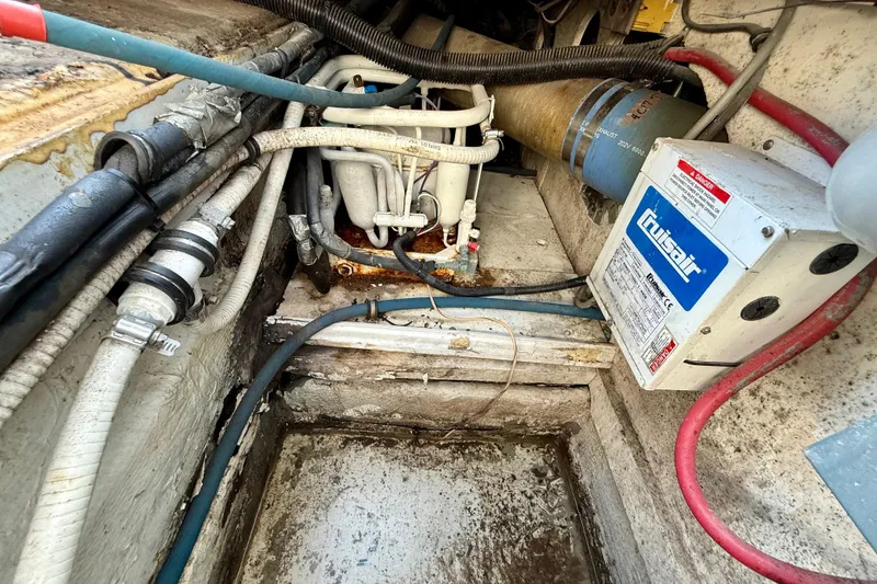 Slide: The Image of Engine compartment of a 1979 Bertram 35 Flybridge with Cruisair system and various cables. - 47