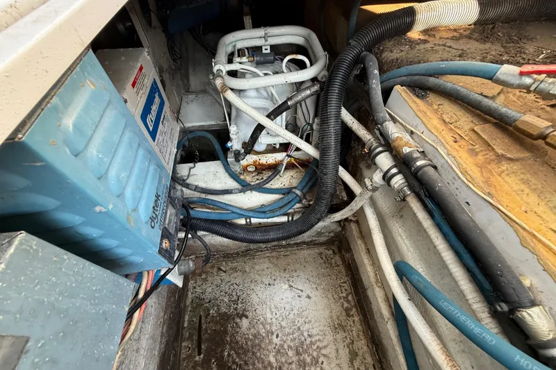 Slide: The Image of Engine compartment of a 1979 Bertram 35 Flybridge with visible wiring and components. - 48