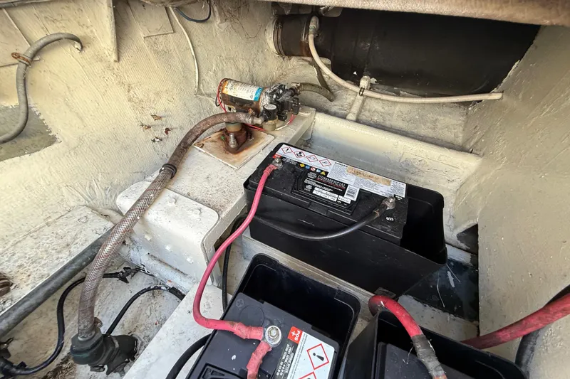 Slide: The Image of 1979 Bertram 35 Flybridge engine compartment with battery and wiring. - 51
