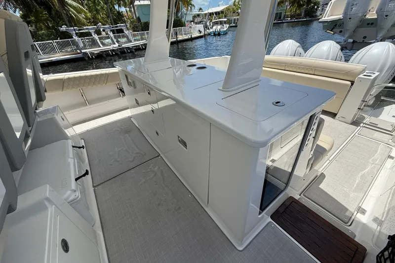 Slide: The Image of 2022 Regal 38 SAV boat interior with sleek cabinetry and seating by the water. - 15