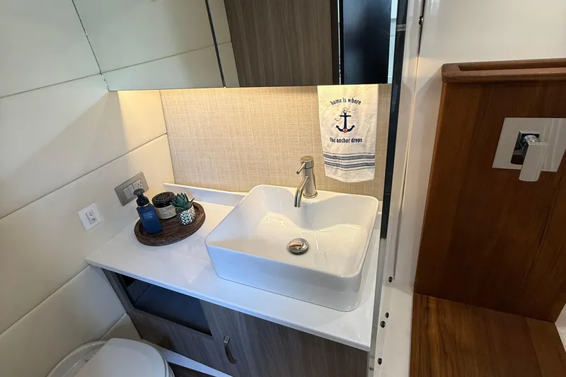 Slide: The Image of Modern bathroom in 2022 Regal 38 SAV yacht with stylish sink and nautical decor. - 23