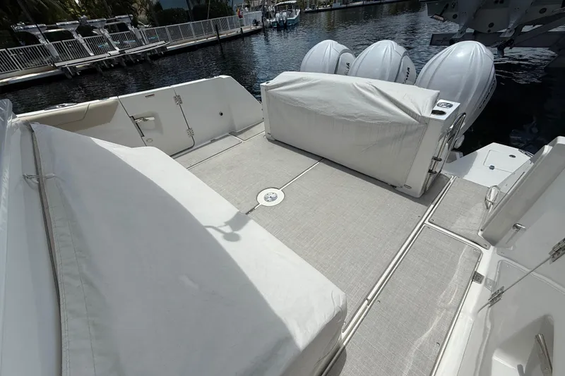 Slide: The Image of 2022 Regal 38 SAV boat deck with covered seating and outboard engines. - 33