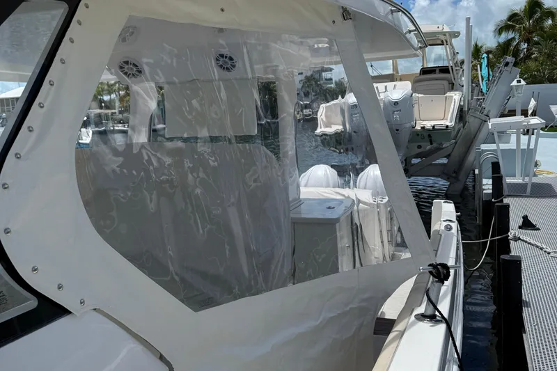 Slide: The Image of 2022 Regal 38 SAV boat docked, featuring clear enclosure and modern design. - 39