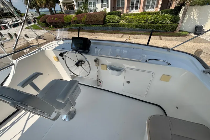 Slide: The Image of Upper Helm on 2005 Nordic Tug 37 Flybridge with centerline armchair Captains seat and collapsable electronics panels that lower into helm console. - 11