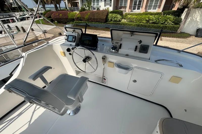 Slide: The Image of Upper Helm on 2005 Nordic Tug 37 Flybridge with Electronics panels that store away into console for protection. - 13