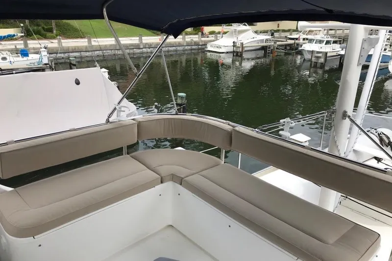 Slide: The Image of Flybridge seating on 2005 Nordic Tug 37, overlooking marina with docked boats. - 15