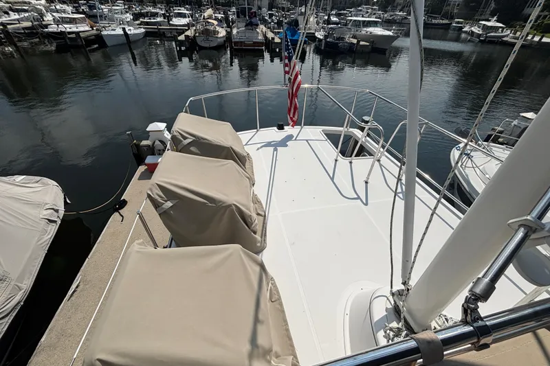 Slide: The Image of Aft Deck on 2005 Nordic Tug 37 Flybridge featuring deck chairs, space for dingy and hinged mast with boom - 19