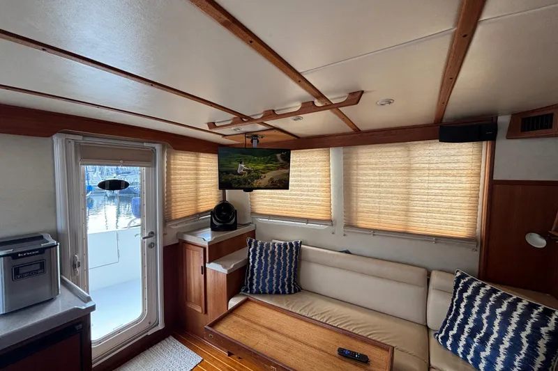 Slide: The Image of Interior of 2005 Nordic Tug 37 Flybridge with cozy seating and modern amenities. - 22