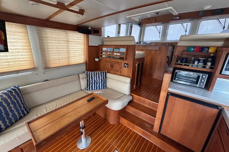 Slide: The Image of Interior of 2005 Nordic Tug 37 Flybridge with cozy seating and wooden finishes. - 27