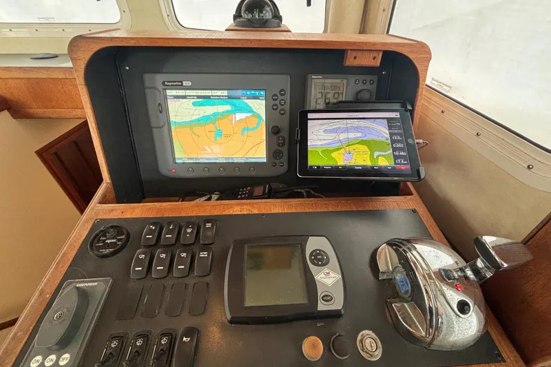 Slide: The Image of Navigation equipment on 2005 Nordic Tug 37 Flybridge, featuring GPS and control panel. - 40